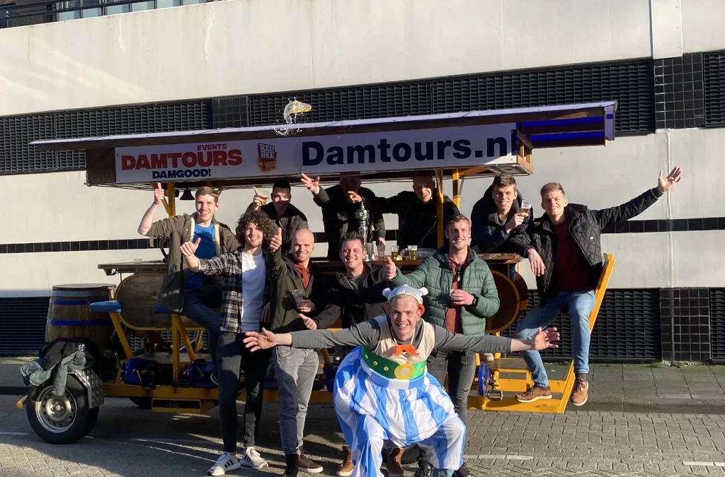 Group of friends enjoying beer bike tour in Amsterdam